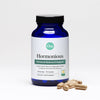 A blue bottle of Hormonious hormonal balance and support capsules with a handful of capsules laying next to the bottle. 